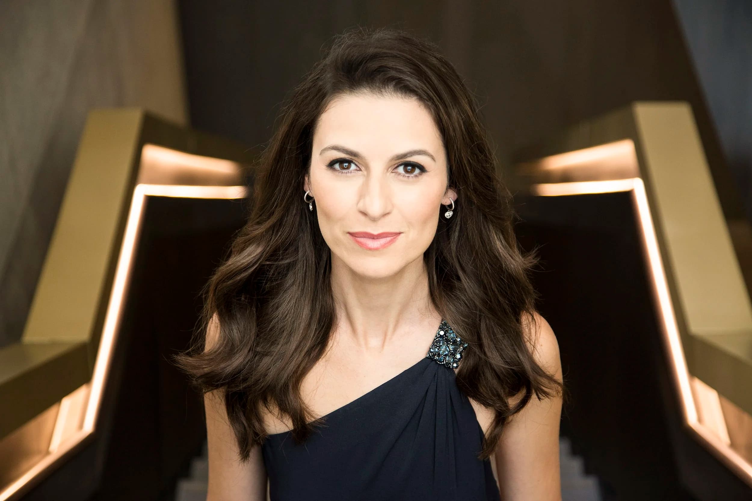 Portrait of soprano Chen Reiss on a golden staircase